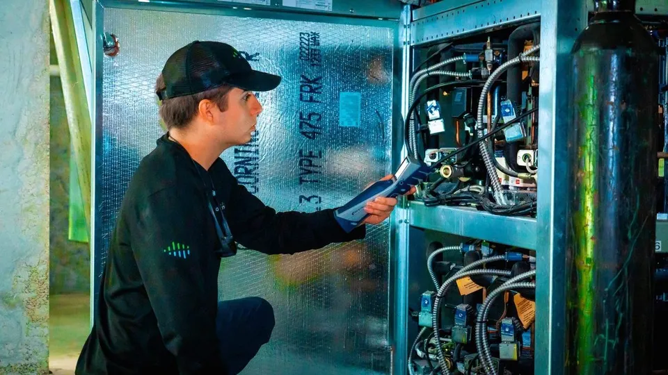 Commercial refrigeration system being serviced to protect stored products